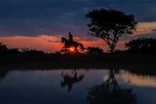 Ant´s Africa Safaris, Flußlandschaft im Sonnenuntergang, Reiter mit Pferd, Spiegelung im Wasser