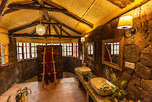 Badezimmer in der Schlafzimmer mit Doppelbett in der Mount Gahinga Lodge