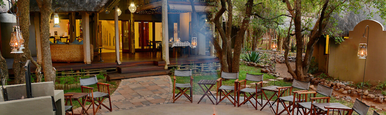 Außenansicht der Tambuti Lodge mit Lagerfeuer