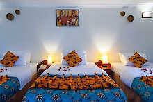 Dreibettzimmer in der Davinci Gorilla Lodge